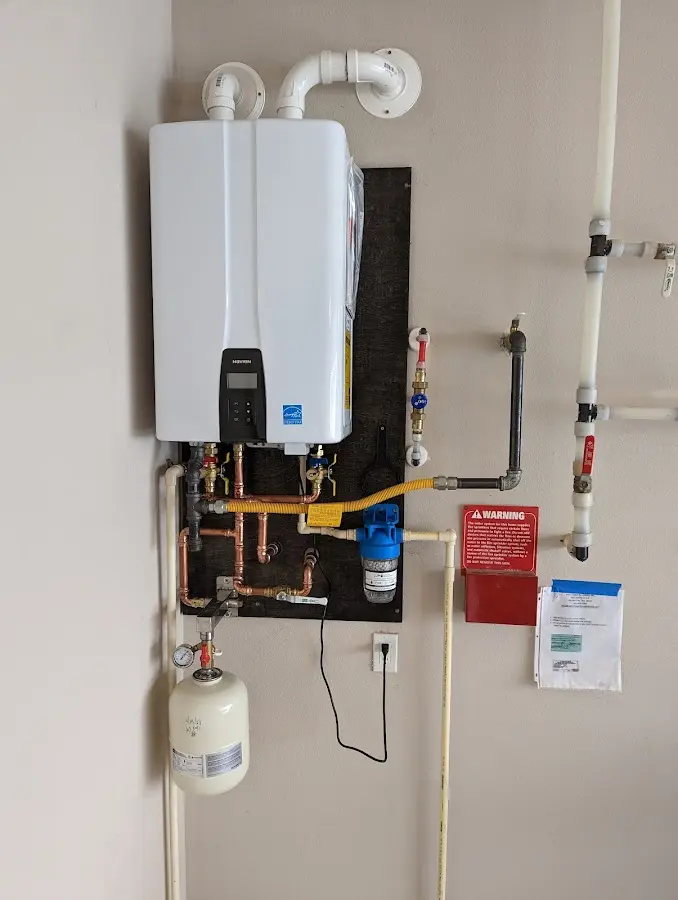 Professional plumber installing copper piping in a Belville home